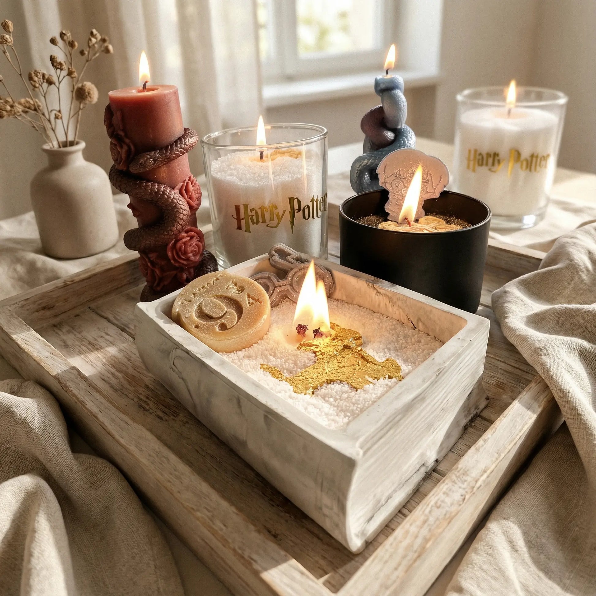 Complete Harry Potter candle set featuring concrete spellbook, black jar, glass jar, and snake sculpture