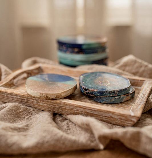 Close up of handmade resin coasters with gold leaf and ocean marble swirl - ريزين هاند ميد