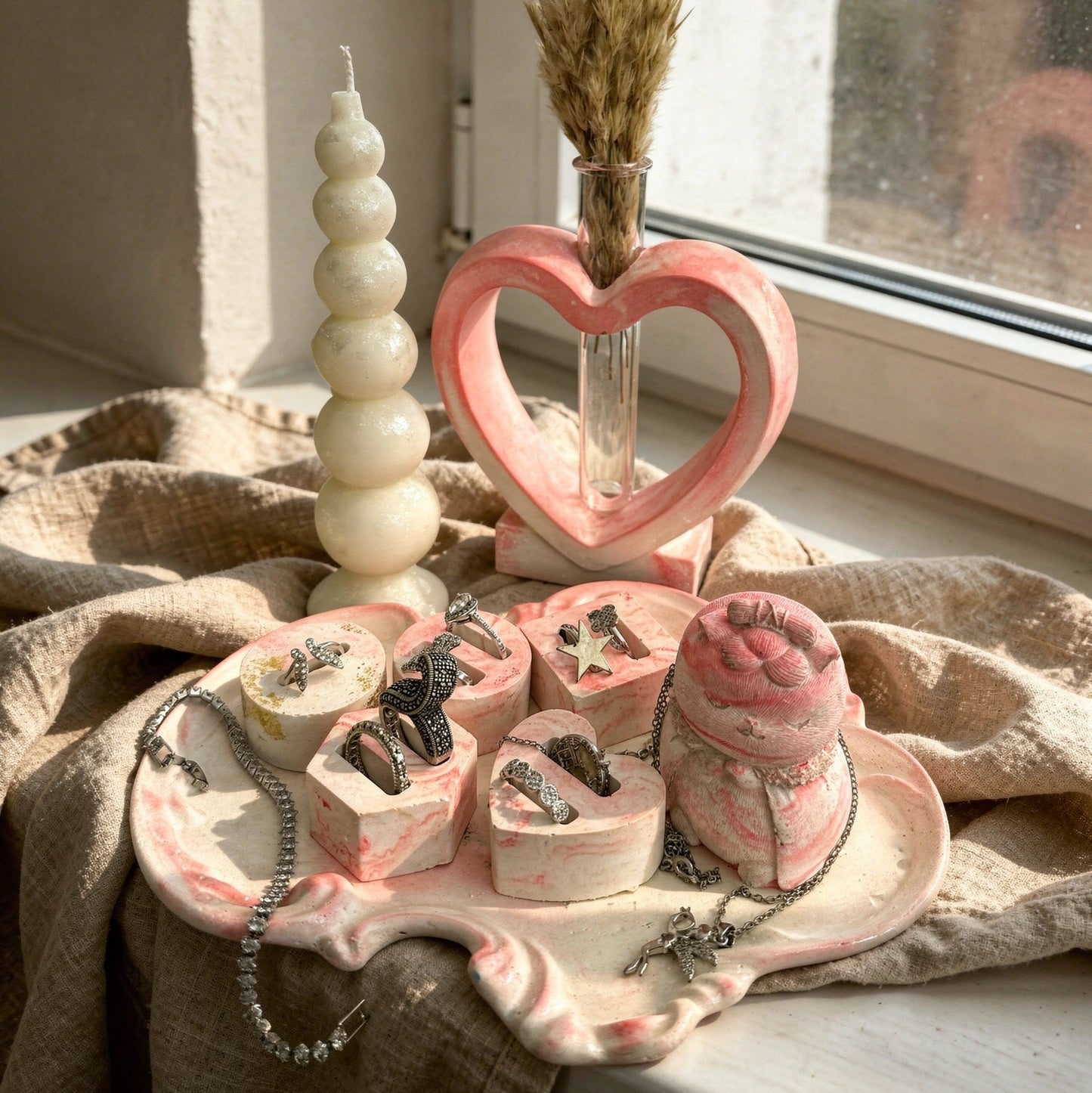 Royal pink dressing table set with pink marble tray, 5 jewelry holders, pink Japanese cat figure, heart vase, and bubble candle.