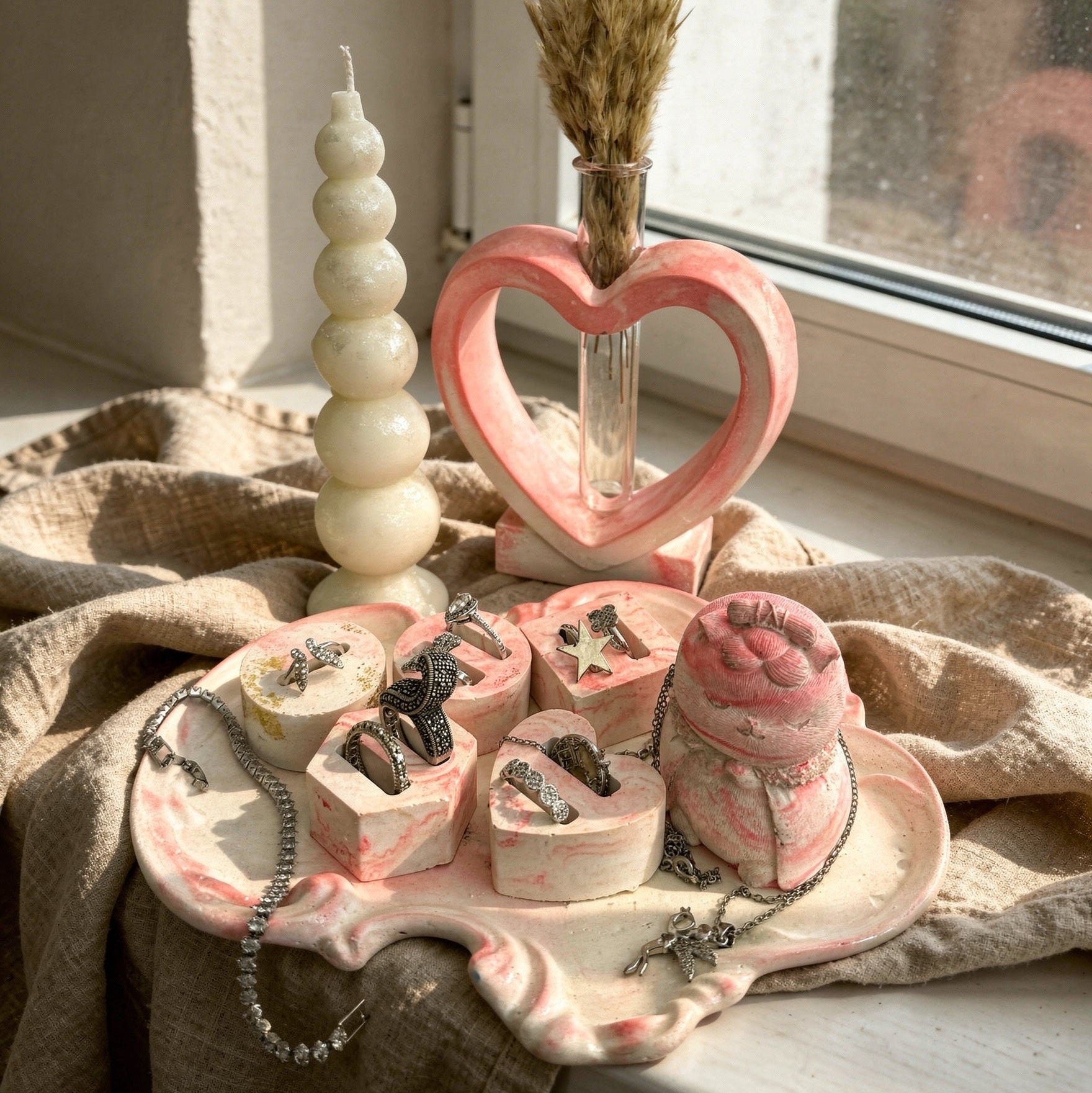 Royal pink dressing table set with pink marble tray, 5 jewelry holders, pink Japanese cat figure, heart vase, and bubble candle.