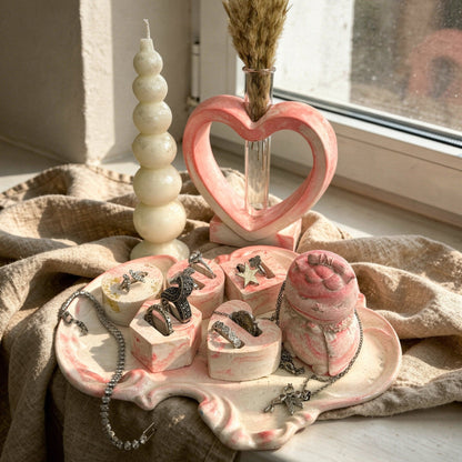 Royal pink dressing table set with pink marble tray, 5 jewelry holders, pink Japanese cat figure, heart vase, and bubble candle.